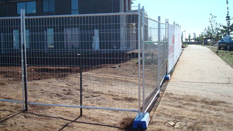 Welded wire temporary panels as construction site barrier.