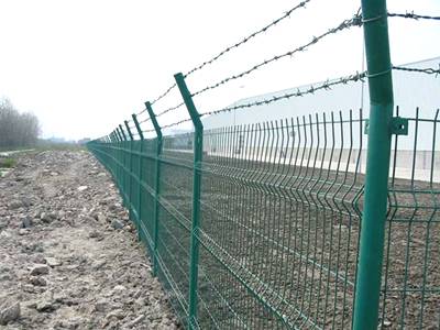 Green vinyl-coated barbed wire combined with general welded wire fence.