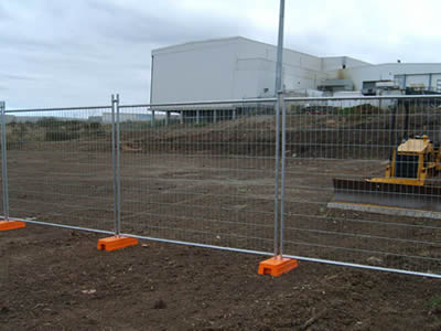 This is temporary fencing with orange base in construction site.