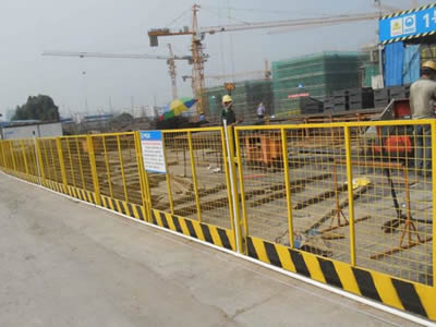 This is construction site with yellow welded wire construction fence.