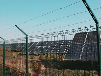 There is welded wire fence with barb wire in photovoltaic power station.