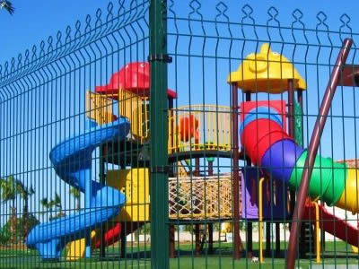 This is a children's playground with single welded wire fence.